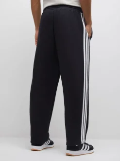 adidas Noir - Pantalons à jambe large en polaires à trois rayures Essentials